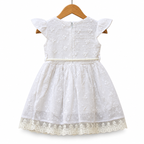 Delicate lace embroidery and whimsical pom-pom accents
