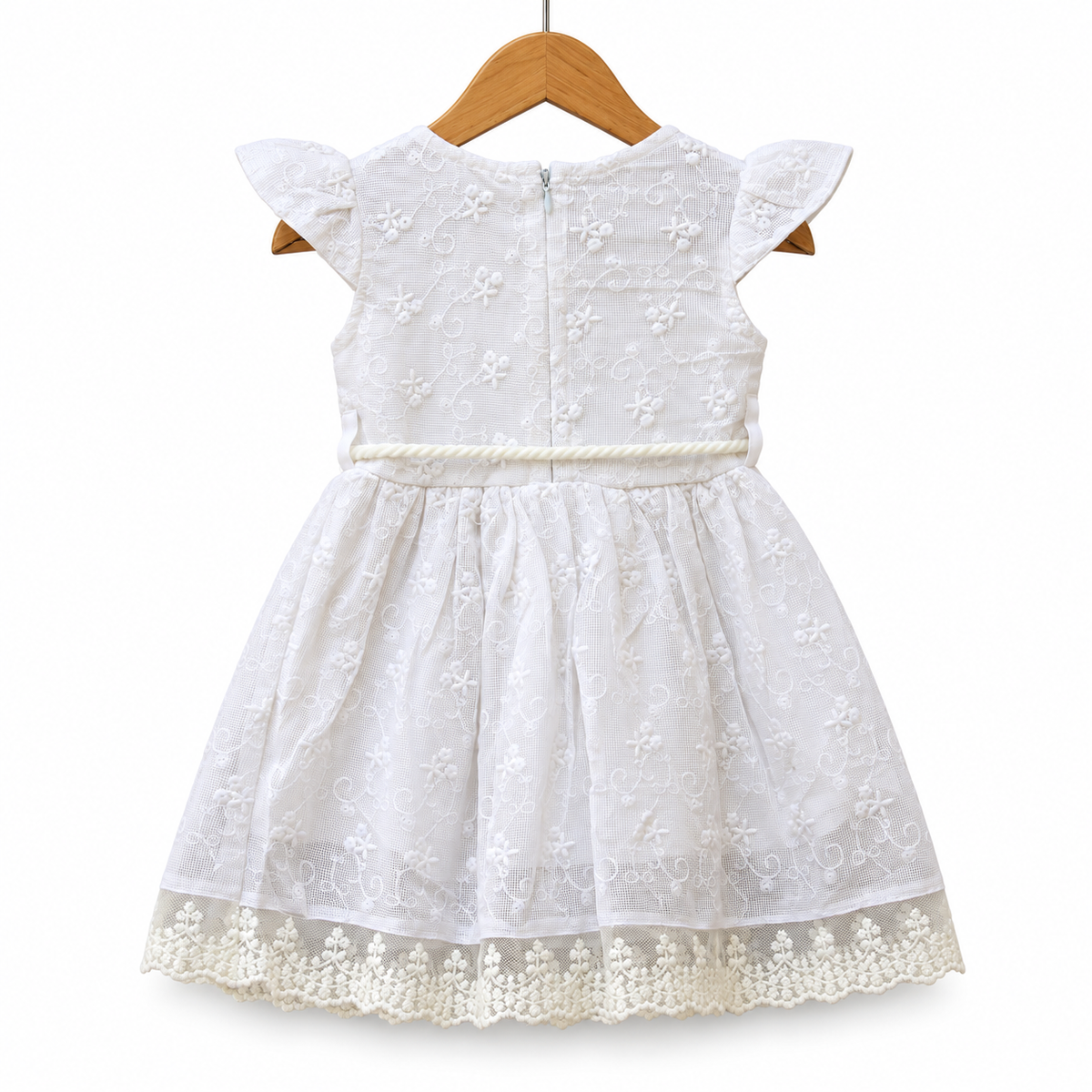 Delicate lace embroidery and whimsical pom-pom accents